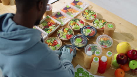 Black-Male-Worker-Applying-Stickers-on-Containers-with-Healthy-Meals